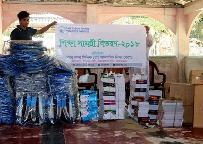 Stacks of school bags, books and supplies ready for distribution