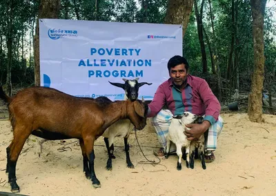 A man with the goats he received from the Poverty Alleviation Program