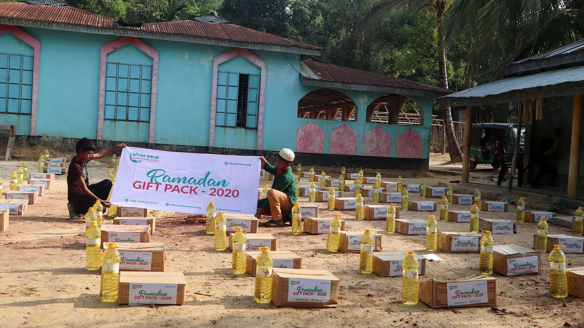 Ramadan gift packs of food and cooking oil laid out for distribution
